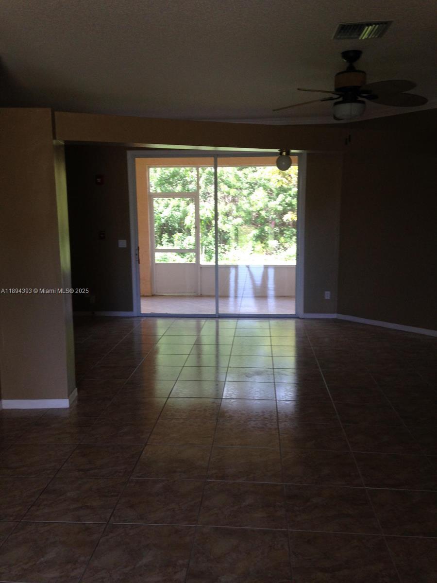 4634 Southwest Eagle Street Port St. Lucie, FL 34953 - Photo 14 of 16 a view of empty room with wooden floor and fan