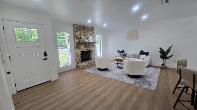 a kitchen with stainless steel appliances a stove a sink cabinets and a window