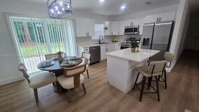 a backyard of a house with plants and large trees