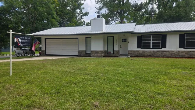 a living room with furniture a rug and a large window