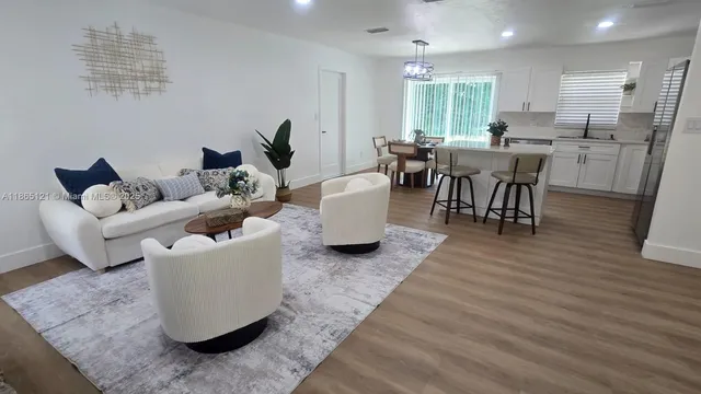 a living room with furniture a fireplace and a potted plant