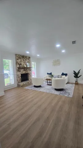 a living room with furniture a rug and a table