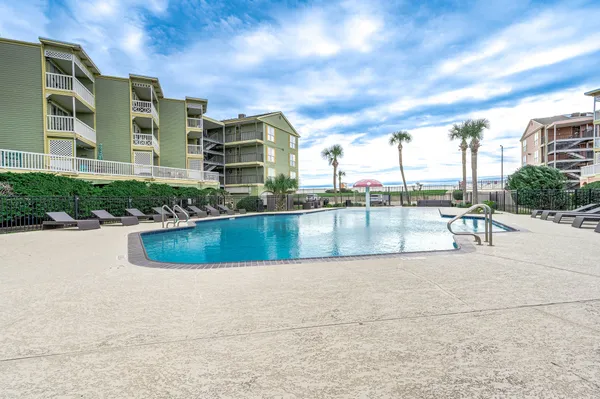 a view of swimming pool with outdoor seating and plants