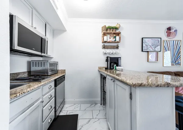 a kitchen with stainless steel appliances granite countertop a sink and a stove top oven