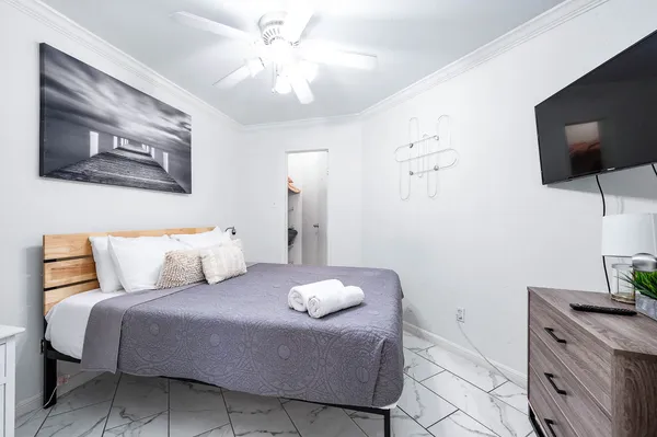 a bedroom with a bed and a flat screen tv