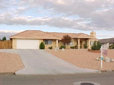 16503 Kasota Road Apple Valley, CA 92307 - Photo 1 of 1 a front view of a house with a yard and garage