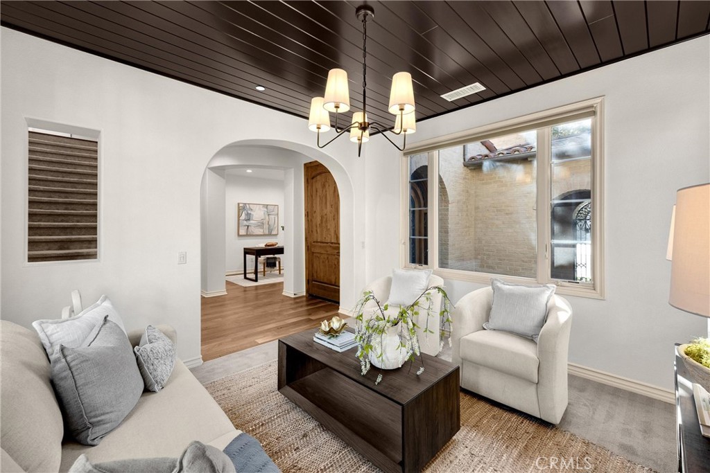 34 Tall Hedge Irvine, CA 92603 - Photo 20 of 75 a living room with furniture and a chandelier