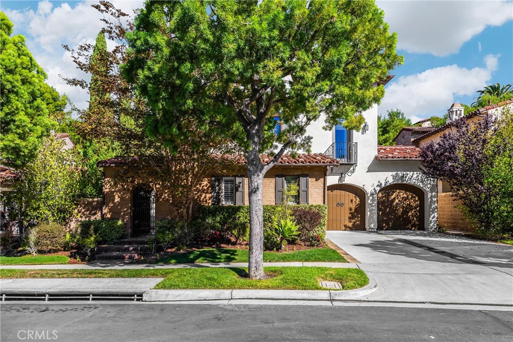 34 Tall Hedge Irvine, CA 92603 - Photo 2 of 75 a front view of a house with a garden
