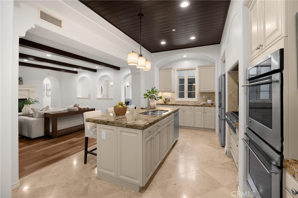 34 Tall Hedge Irvine, CA 92603 - Photo 36 of 75 a kitchen with stainless steel appliances granite countertop a sink and cabinets