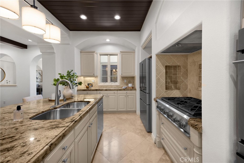 34 Tall Hedge Irvine, CA 92603 - Photo 37 of 75 a kitchen with stainless steel appliances kitchen island granite countertop a sink a stove and cabinets