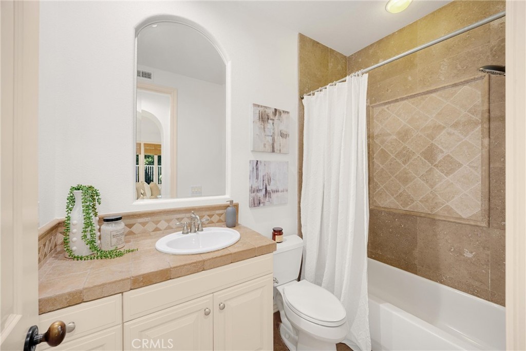 34 Tall Hedge Irvine, CA 92603 - Photo 42 of 75 a bathroom with a sink a toilet and shower