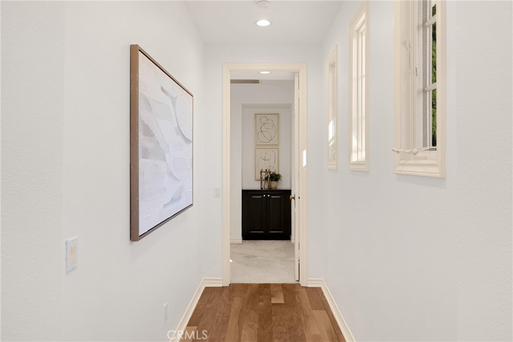 34 Tall Hedge Irvine, CA 92603 - Photo 52 of 75 a view of a hallway with wooden floor and staircase