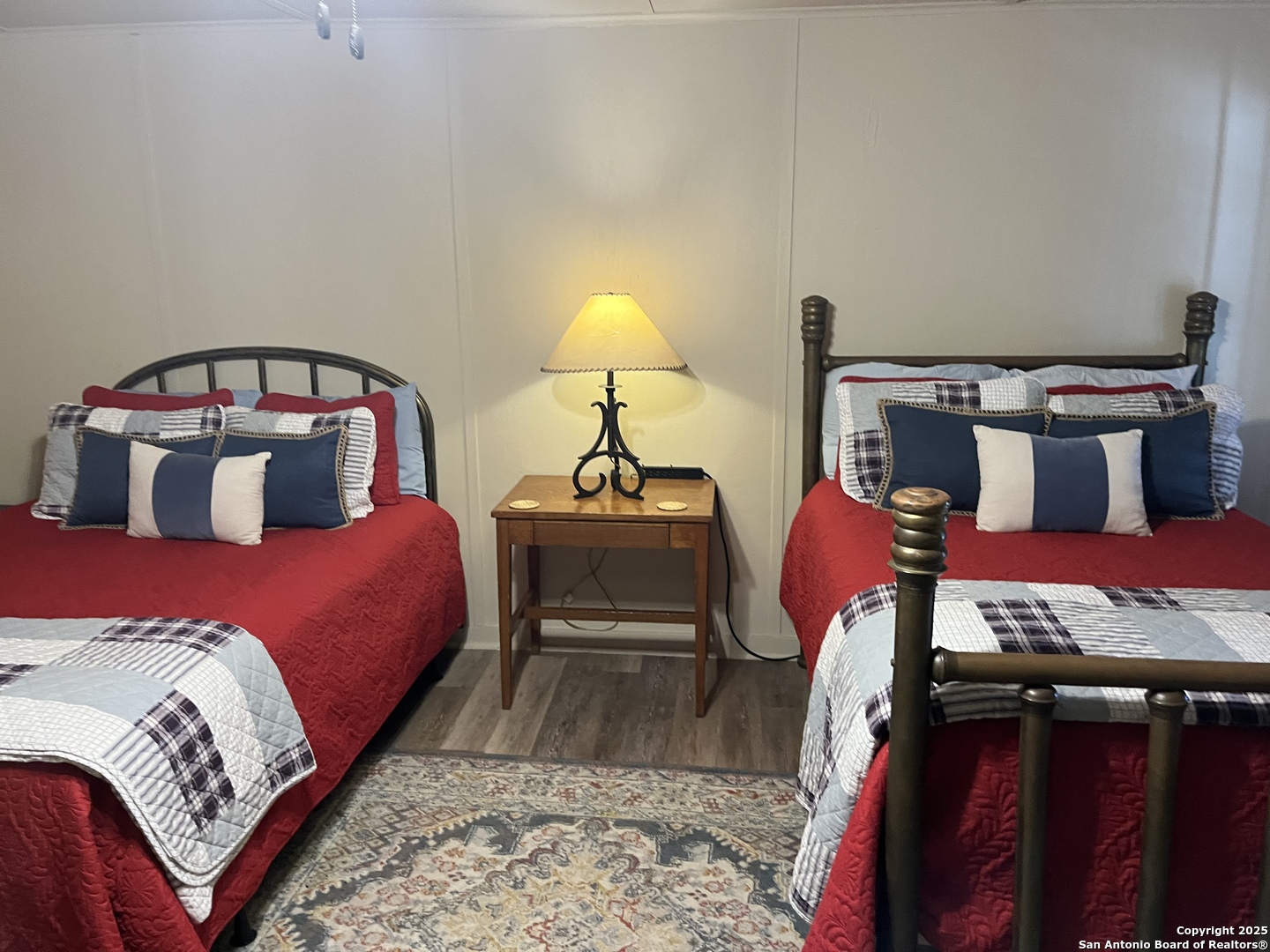4664 Rocky Road Blanco, TX 78606 - Photo 13 of 27 a bedroom with a bed and wooden floor