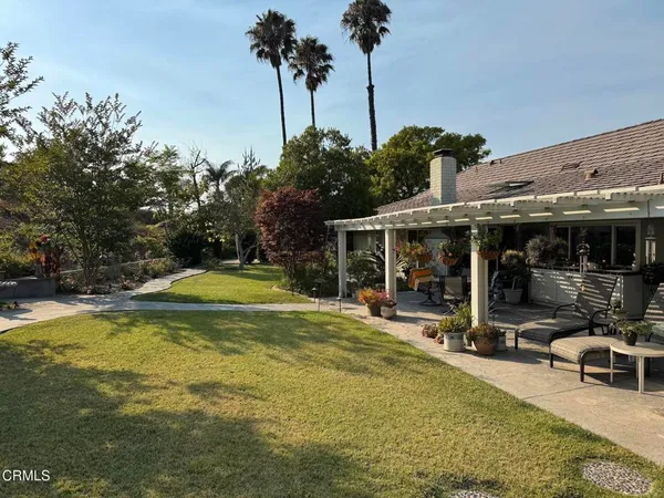 a view of a house with swimming pool and sitting area