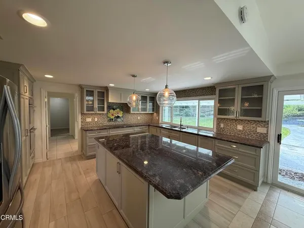 a kitchen with stainless steel appliances granite countertop a sink and a stove