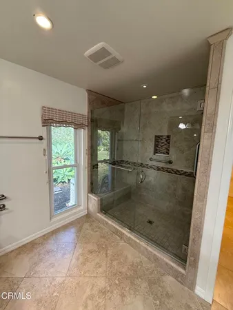 a bathroom with a glass shower door