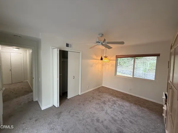a view of an empty room and a window
