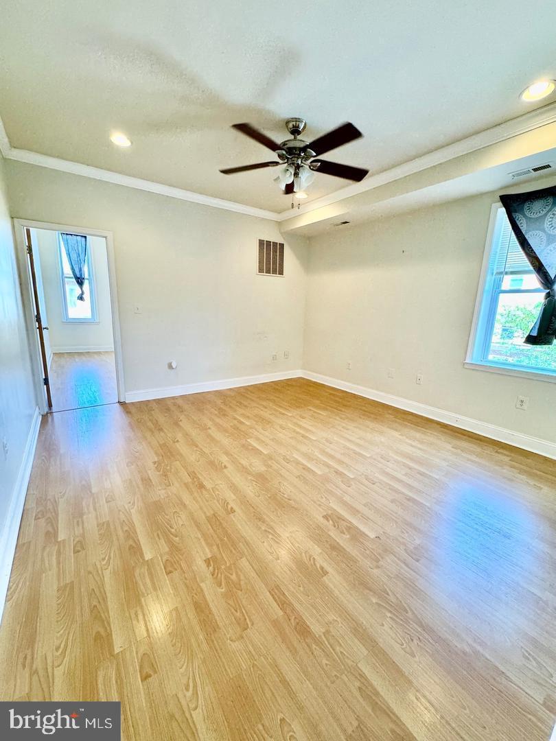 445 East Fort Avenue, Unit A Baltimore, MD 21230 - Photo 7 of 18 wooden floor in an empty room with a window