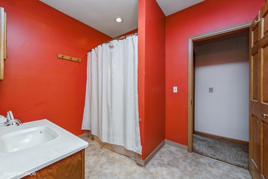 14-n043 Reinking Road Hampshire, IL 60140 - Photo 11 of 12 a view of a bathroom with a sink and a mirror