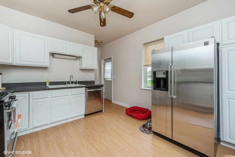 14-n043 Reinking Road Hampshire, IL 60140 - Photo 4 of 12 a kitchen with a refrigerator and countertop
