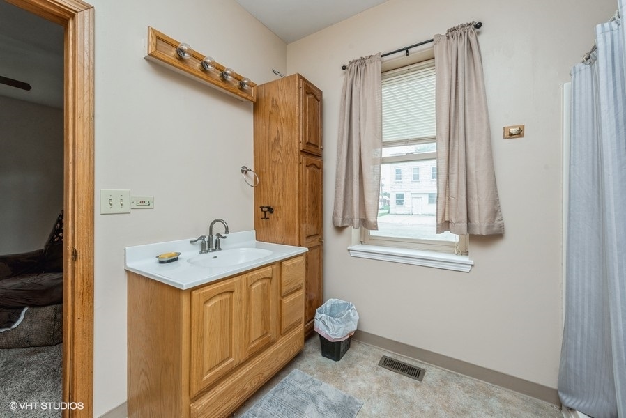 14-n043 Reinking Road Hampshire, IL 60140 - Photo 10 of 12 a bathroom with a sink a mirror and a shower