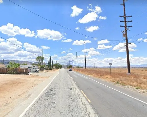 a view of a street with a building in the background