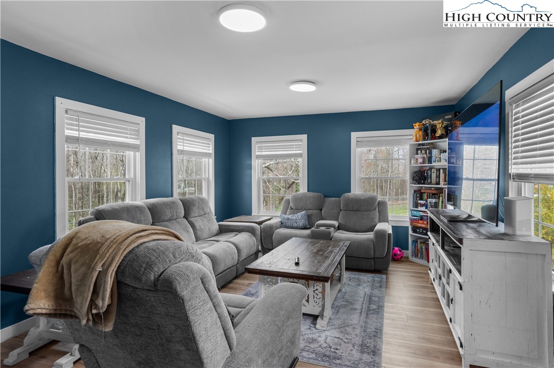 a living room with furniture a rug and a large window