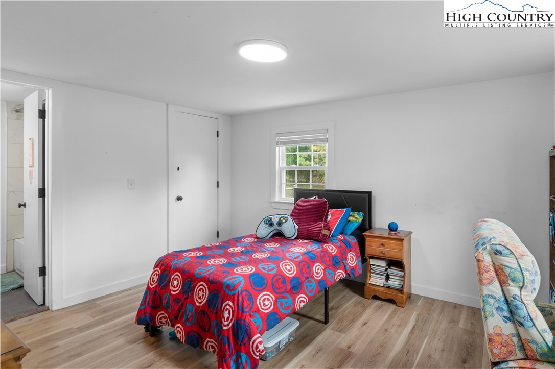379 Pat Nixon Road State Road, NC 28676 - Photo 27 of 41 a bedroom with a bed and wooden floor