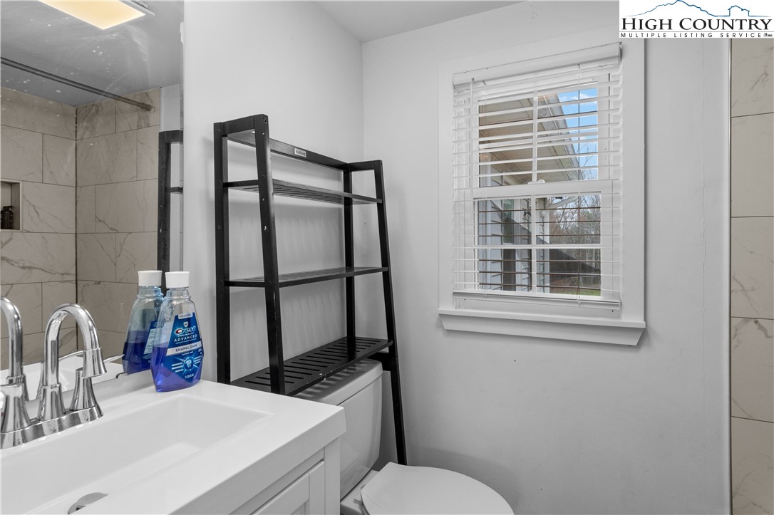 379 Pat Nixon Road State Road, NC 28676 - Photo 29 of 41 a bathroom with a sink toilet and window