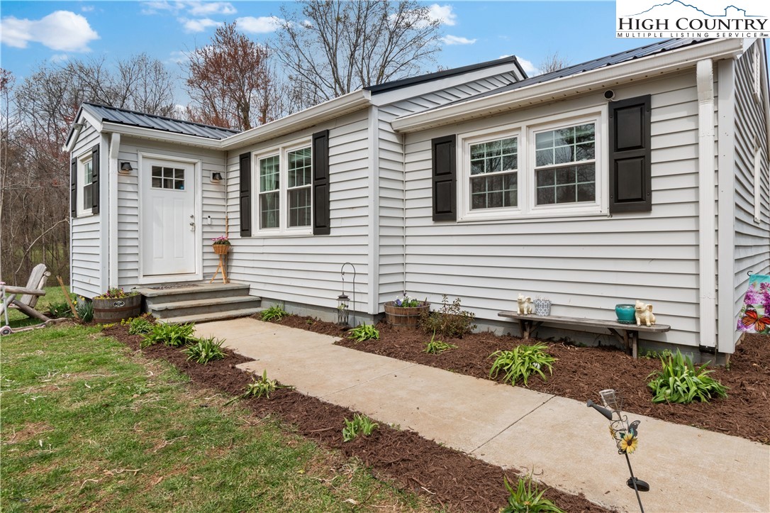 379 Pat Nixon Road State Road, NC 28676 - Photo 9 of 41 a front view of a house with a yard and a garage