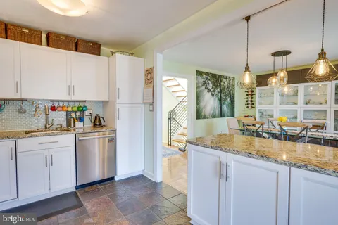 a kitchen with a sink dishwasher a refrigerator and a stove
