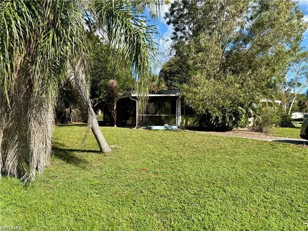 a view of a backyard with a garden and entertaining space