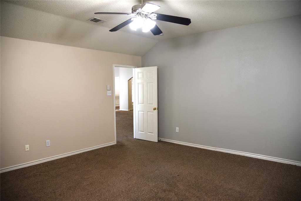 1526 Pebblestone Court Allen, TX 75002 - Photo 12 of 28 Carpeted room with a vaulted ceiling and ceiling fan with lighting