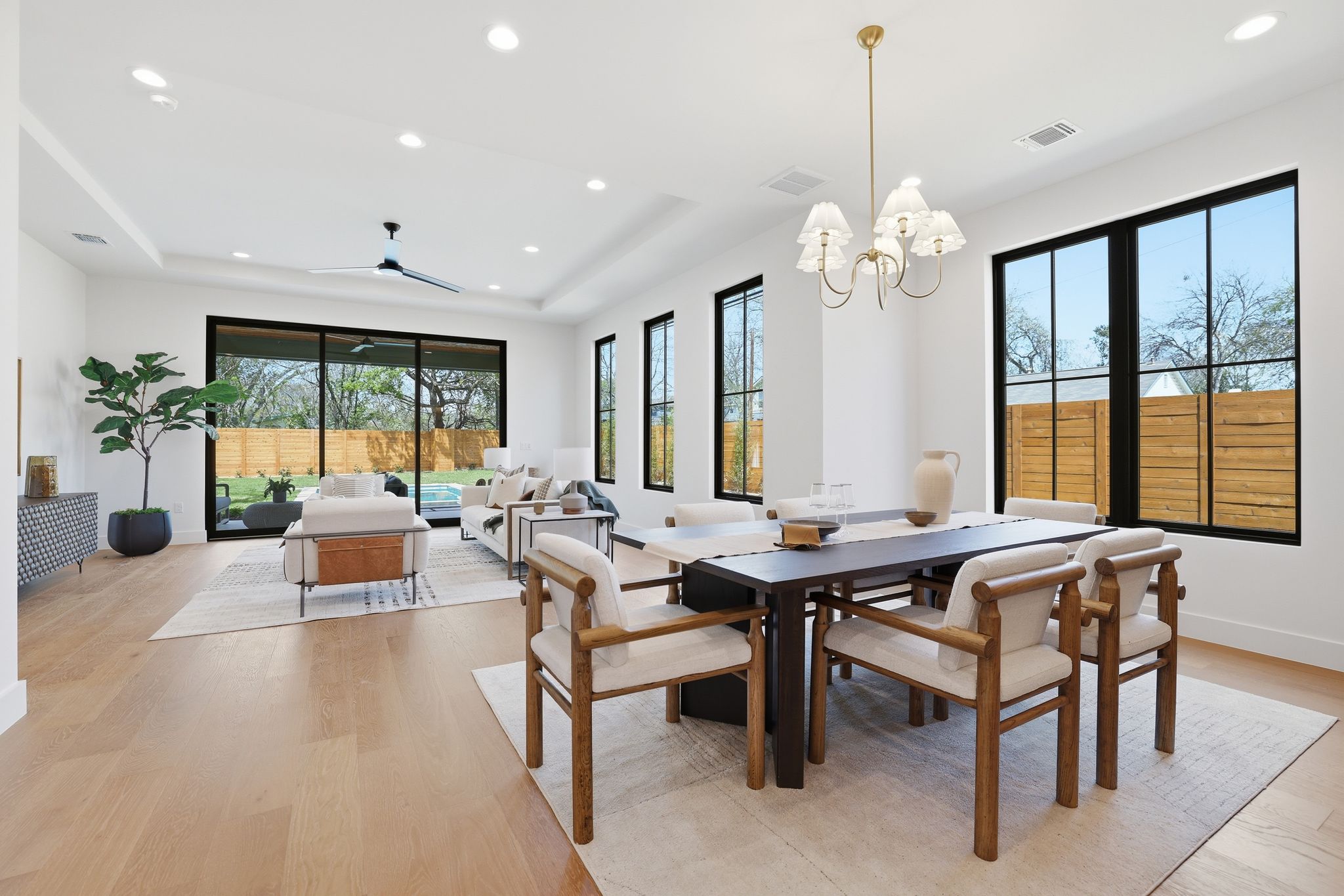 4500 Jinx Avenue Austin, TX 78745 - Photo 17 of 40 Dining room with light wood-style floors, a ceiling fan, a raised ceiling, and hanging lights
