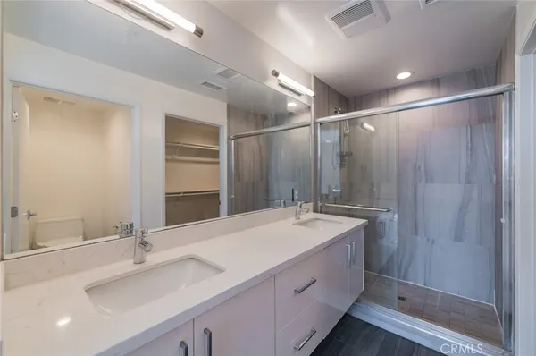 a bathroom with a sink double vanity and a mirror