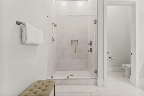 a bedroom with a large bed and a flat screen tv