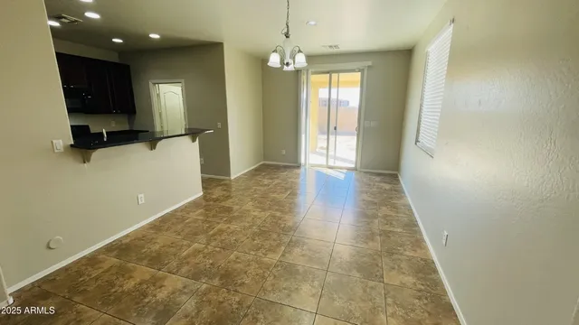a view of hallway with a window and a chandelier