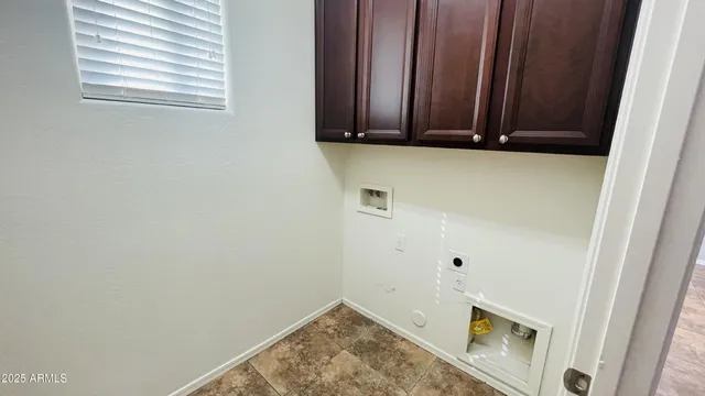 a view of a microwave and utility room