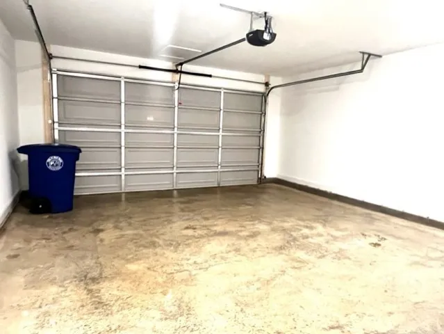 a kitchen with a white cabinets appliances and wooden floor