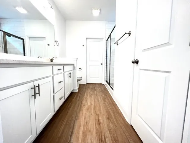a bathroom with a glass shower door