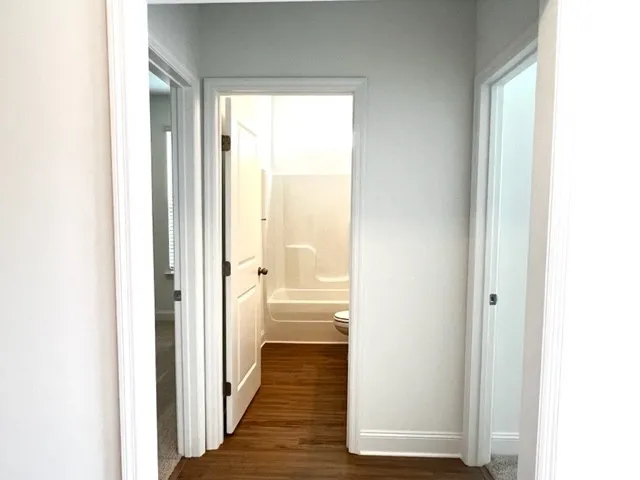 a view of a bathroom from a hallway