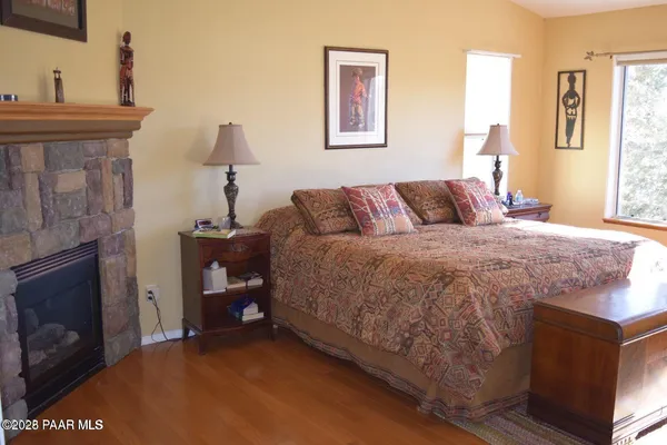 a bedroom with a bed and a fireplace