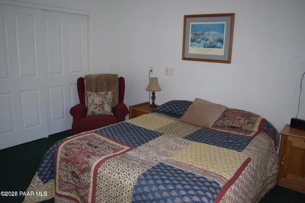 a bedroom with a bed and chair