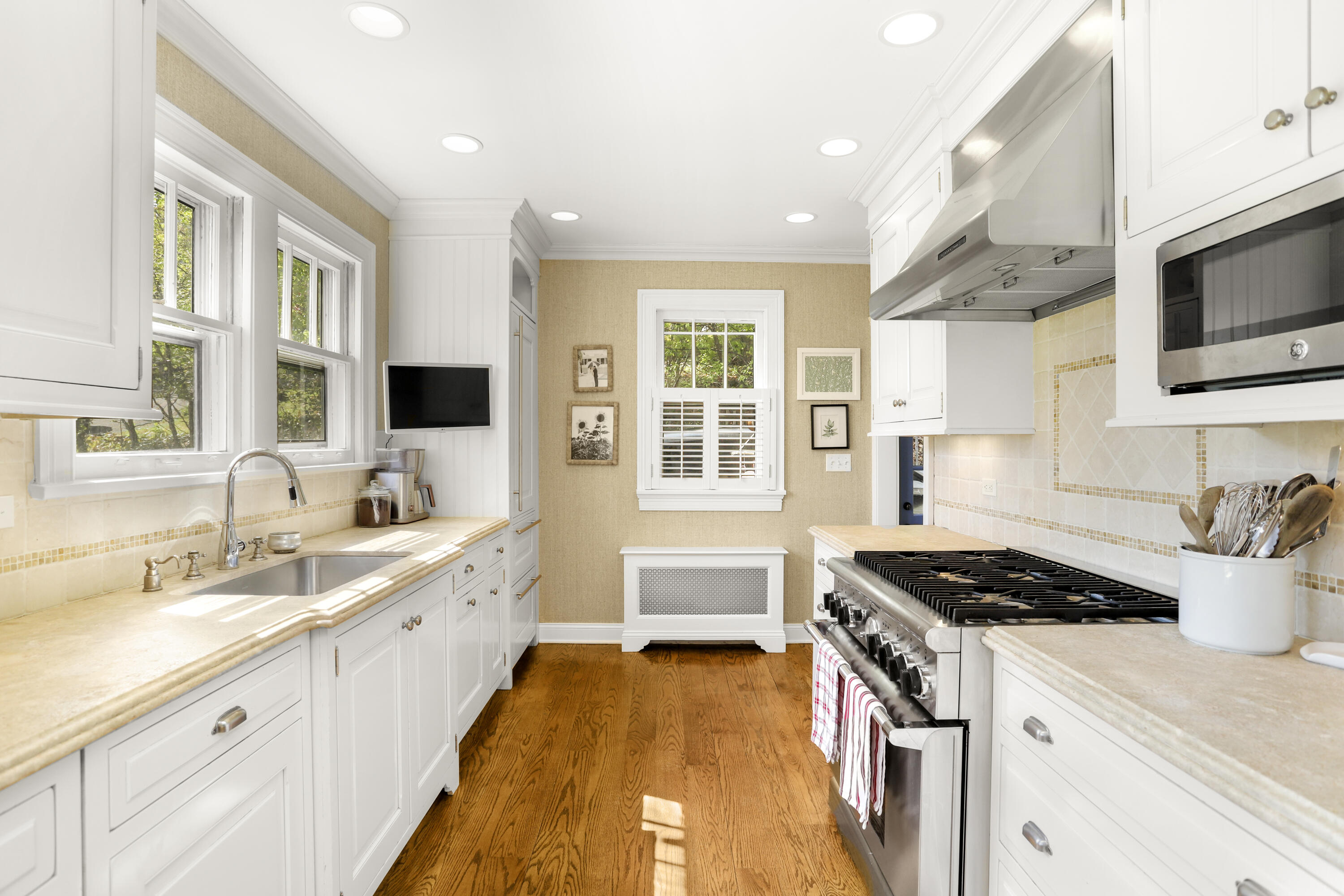 78 Roton Avenue Norwalk, CT 06853 - Photo 12 of 31 a kitchen with stainless steel appliances a stove a sink and a microwave