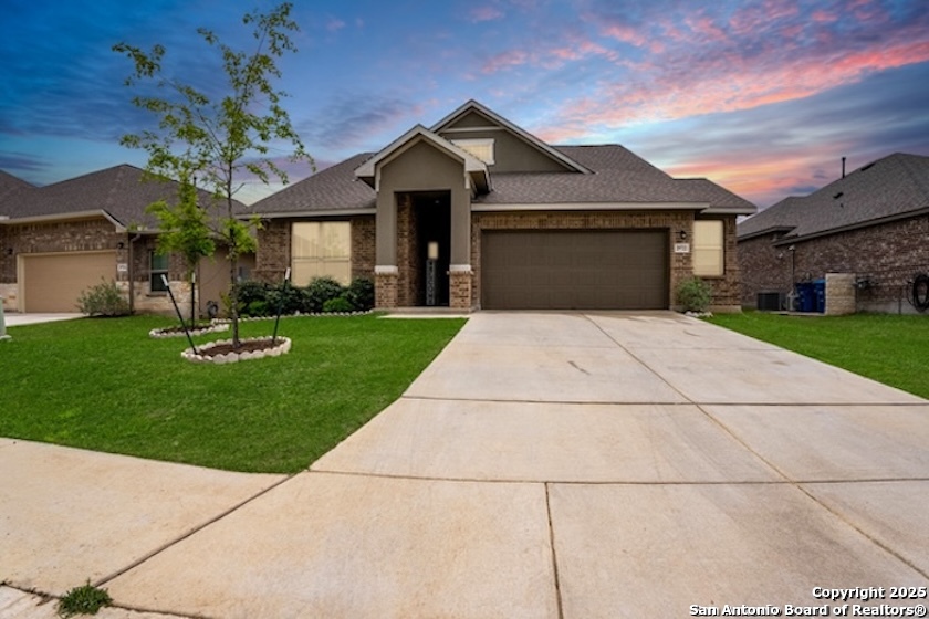 a front view of a house with a yard