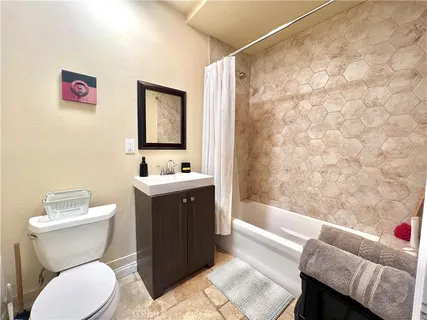 a bathroom with a toilet a sink and a bathtub