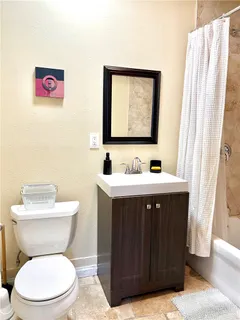 a bathroom with a sink vanity and a toilet
