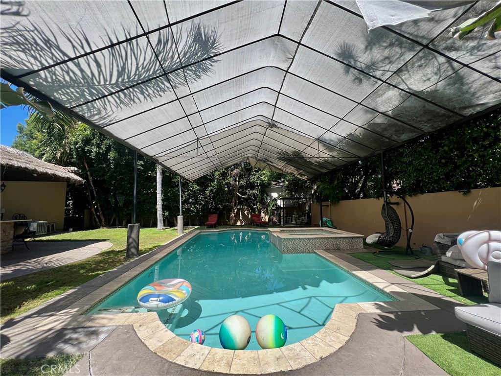 17401 Raymer Street Northridge, CA 91325 - Photo 14 of 19 a view of a swimming pool with a patio