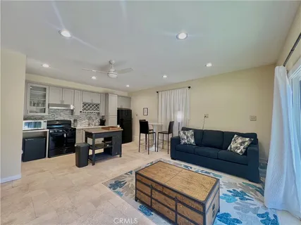 a living room with furniture kitchen view and kitchen view
