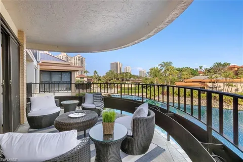 a roof deck with couches and potted plants